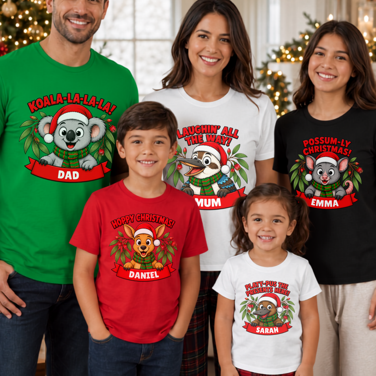 A family of five wearing personalized Christmas graphic t-shirts in different colors (green, white, red, black) featuring koala and possum designs with holiday text, posed together in a festive living room setting with Christmas lights in the background.