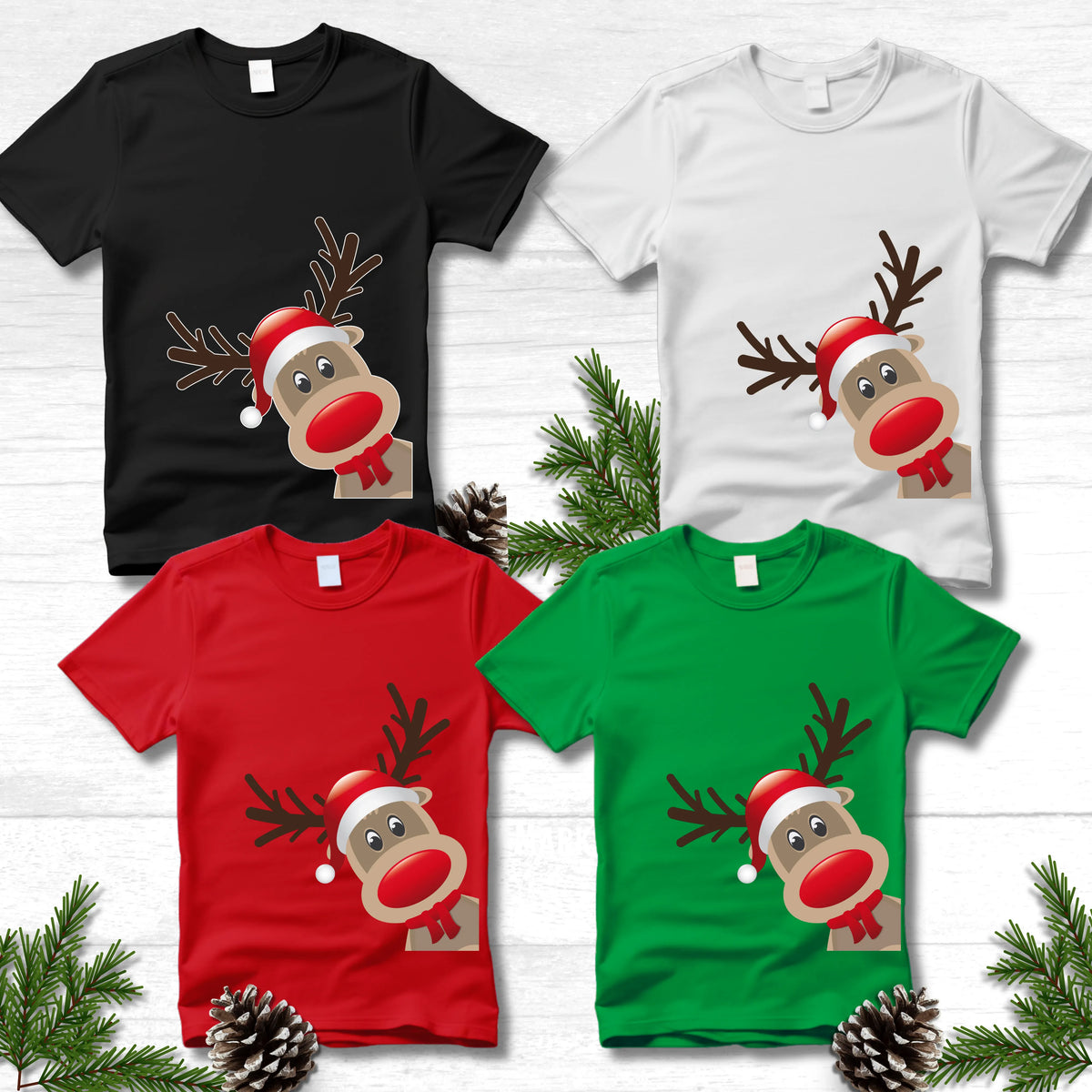 Four Christmas-themed t-shirts with reindeer designs on a white wooden background.