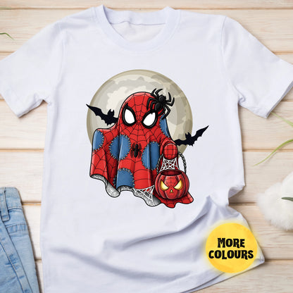 White t-shirt with Spider-Man design holding a pumpkin lantern on a wooden surface.